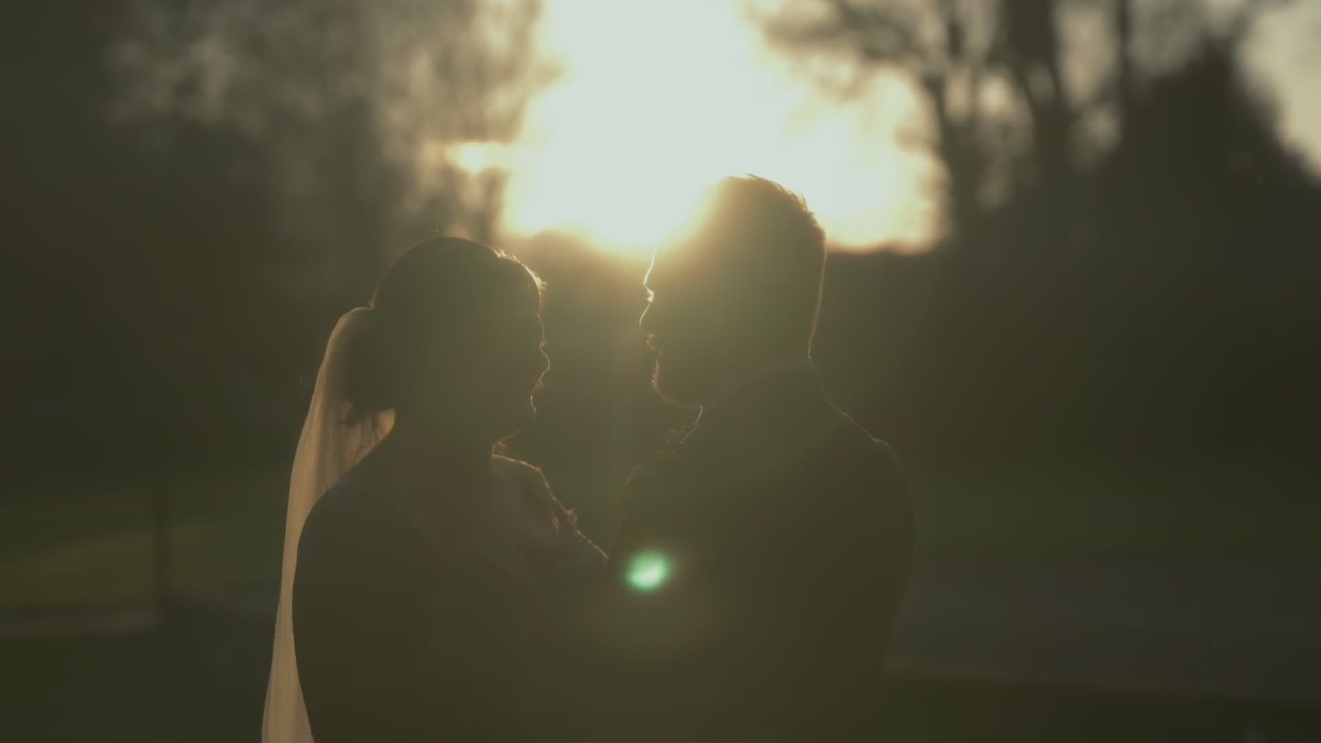 A couple silhouetted against the setting sun