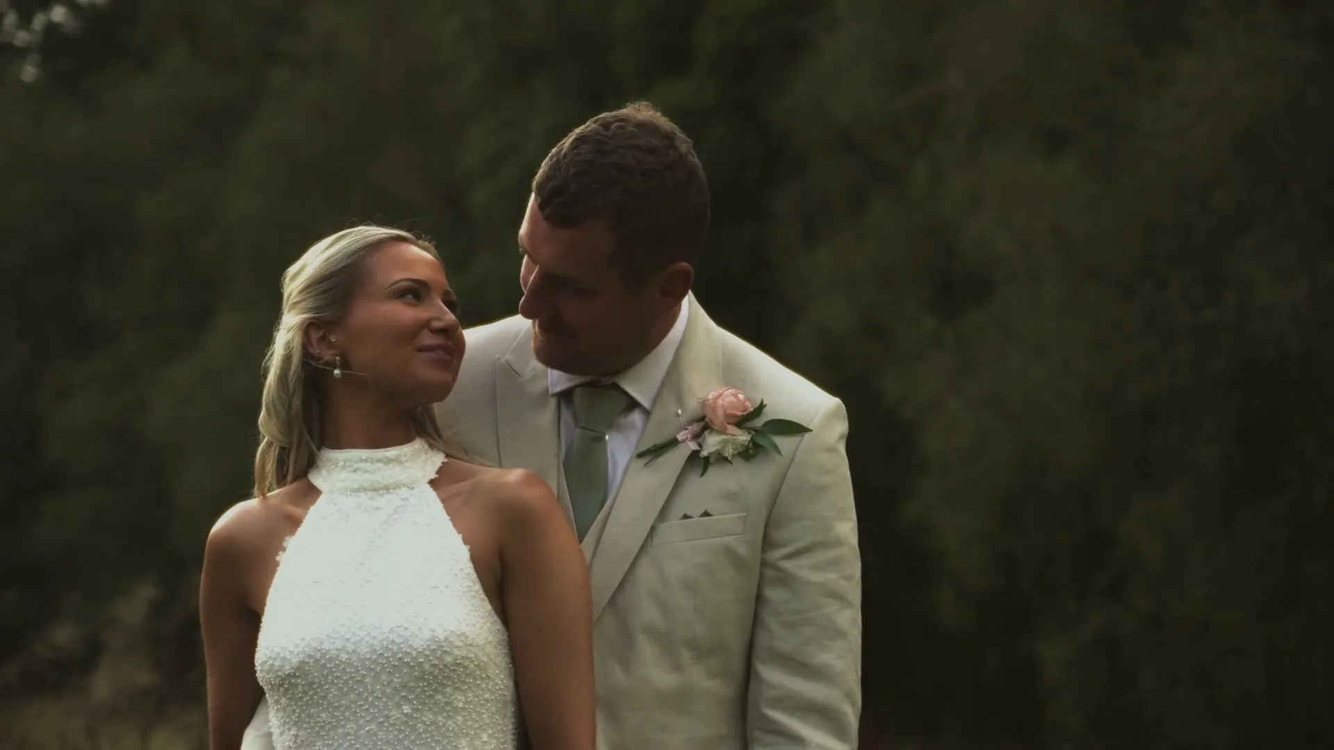 A couple in golden evening light on their wedding day